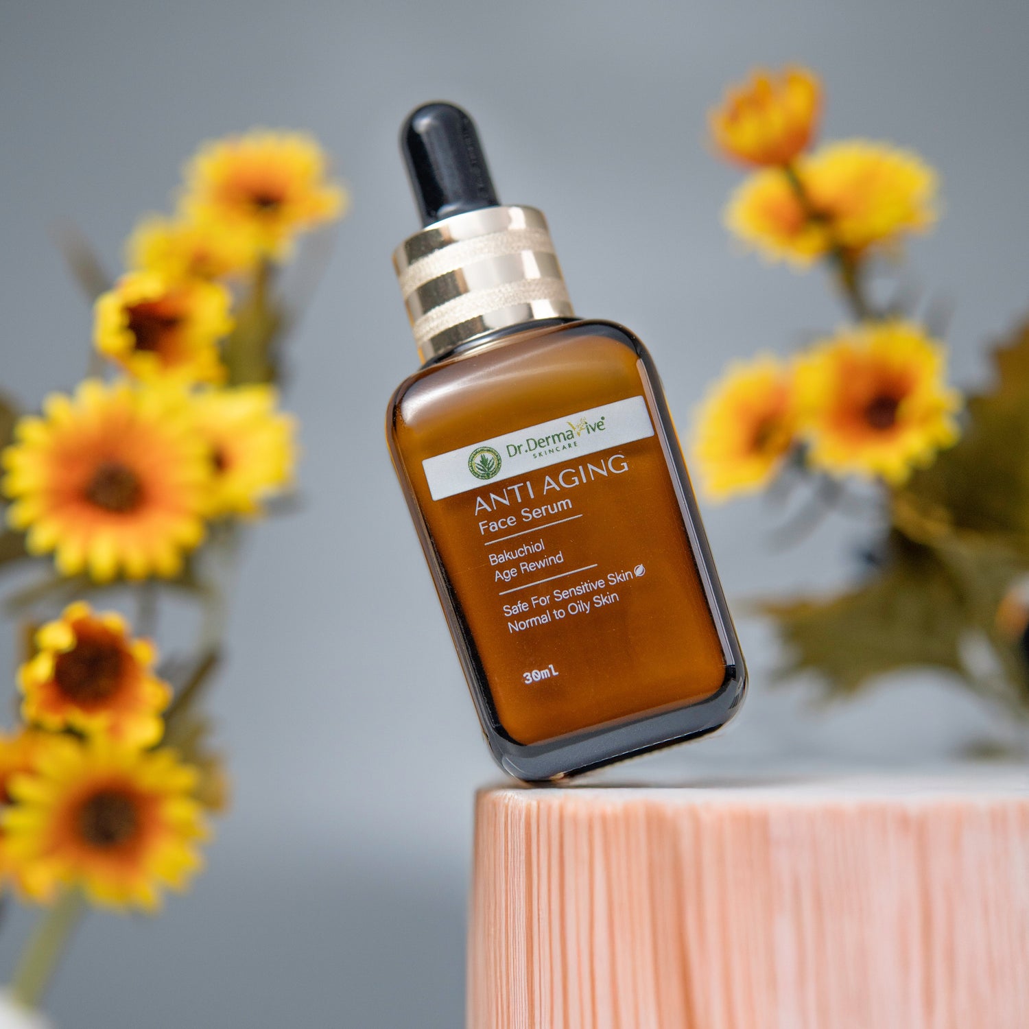 Anti-aging facial serum bottle with sunflowers in the background